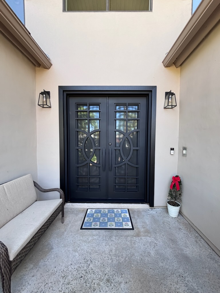 Double iron entry door with patio seating