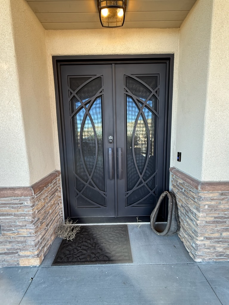 Custom forged iron door with scrollwork in our shop